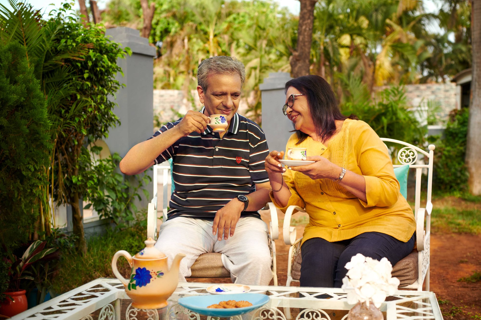 Retired couple enjoying tea together in their garden